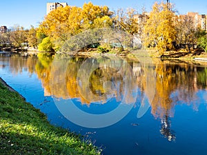 river in urban park in sunny autumn day