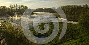 River Venta waterfall in sunny, misty spring morning, Kuldiga, Latvia