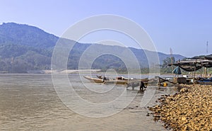 River view in Thailand with black dog and fishing boat,