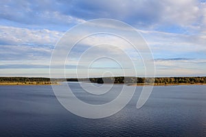 River Volga valley with fields and forest under cloudy sky