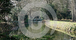 River walk at Lode Cambridgeshire with Bridge, stream and trees.