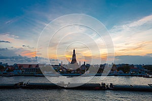 River and Wat Arun Temple during the sunset in Bangkok Thailand