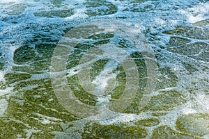 River water bubbles surface background with sunlight