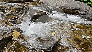 River water flowing in a close view with pebbles