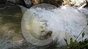 River water flowing passing through mountain rocks slow motion