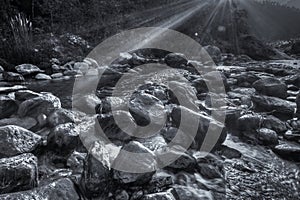 River water flowing through rocks at dawn, Reshi River, Sikkim, India photo