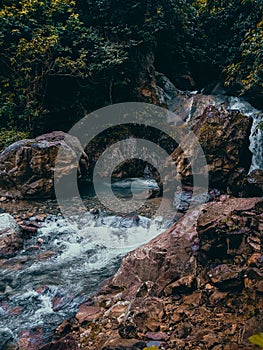 River water that flows swiftly in the middle of large rocks