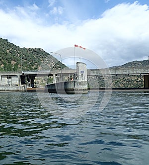 River water and lock with bridge and hills