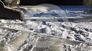 River water move down from a barrier to a lower level. Weirs are building to reduce erosion during storm events