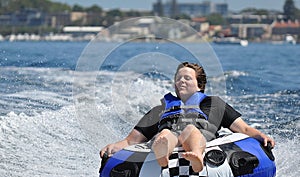 River water tubing skiing teen boy