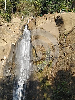 A river waterfall in the middle of a forest that is very beautiful and amazes anyone who sees it