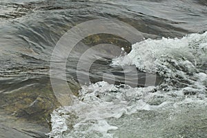 River wave in shallow water