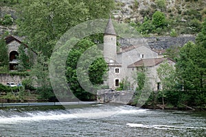 A river weir with a building exterior at day