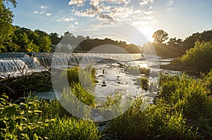 A river weir with trees late afternoon