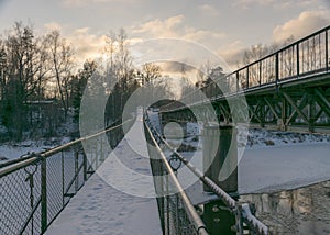 A river in winter, in the backlight of the bridge structure