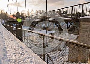 A river in winter, in the backlight of the bridge structure