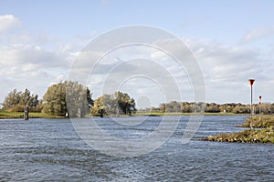 Riverbank and wide view of Dutch waterway