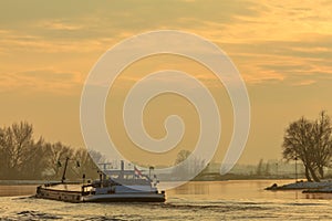 Riverboat during winter on the river IJssel in The Netherlands