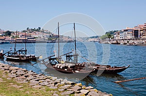 Riverboats with wooden barrels with port wine, old boats from some wineries on river Douro