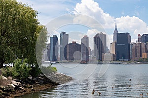 Riverfront of Gantry Plaza State Park in Long Island City Queens New York with a view of the Midtown Manhattan Skyline during Spri