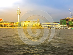 Riverfront view of Samut Prakan city hall with new observation tower and boat pier. Samut Prakan is at the mouth of the Chao