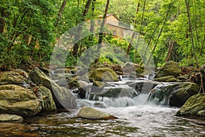 Riverine forest and farmer's house at Sant Marsal creek cascades