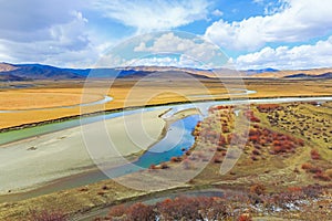 River on yellow grassland in autumn