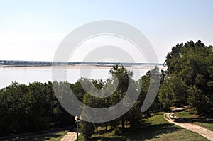 Riverscape with dark trees of a park photo