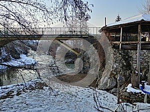 Riverscape view with a bridge and house on winter