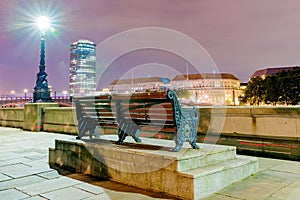 Riverside bench with buildings