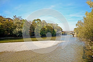 Riverside with bridge across the Isar River in Munich, Bavaria Germany