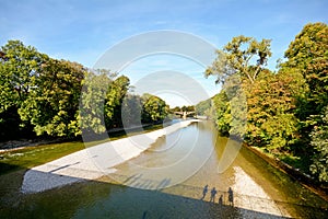 Riverside with bridge across the Isar River in Munich, Bavaria Germany
