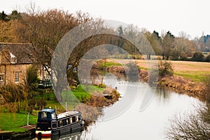 Riverside cottages by the River in the English Countryside with a narrowboat