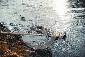 Riverside dock and small boat moored photo