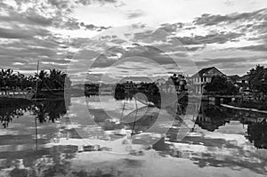 Riverside houses reflected in the Thu Bon river in Hoi An, Vietnam, Indochina, Asia