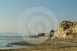 Riverside of a lake on the outskirts of the town of Kardzali in Bulgaria. Chimneys of a steel factory