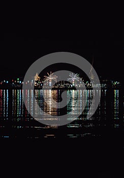 Riverside thai local temple is decorated with different color fireworks in the full moon festval