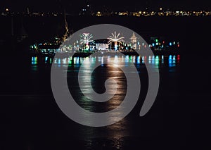 Riverside thai local temple is decorated with different color fireworks in the full moon festval