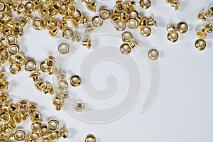 Rivets scattered on a white sheet lying on a gray marble table