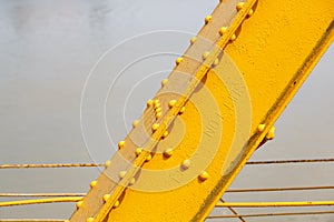 A rivetted steel girder of Papar Railway Bridge, painted yellow photo