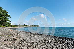 Riviere des Galets Beach in Mauritius. Black stones and Indian Ocean