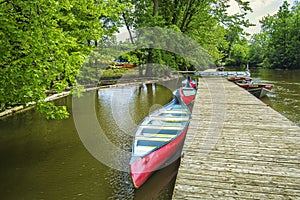 The RiviÃ¨re-des-Mille-ÃŽles Park with canoe and boats at a quay