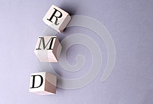 RMD word on wooden block on gray background photo