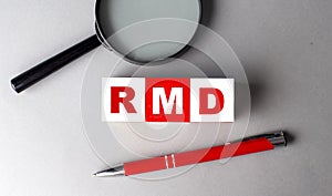 RMD word on wooden cubes with pen and magnifier
