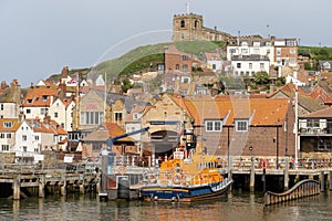 RNLI Whitby Lifeboat Station in Whitby, North Yorkshire, UK, with the lifeboat moored outside