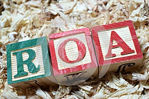 ROA return on assets acronym on wooden blocks photo
