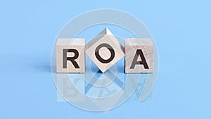 ROA is an abbreviation of the Return On Assets- the text is written on wooden cubes