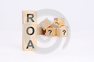 roa - Return On Assets - text on wooden cubes