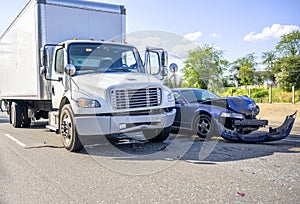 Road accident with damage to vehicles as a result of a collision between a semi truck with box trailer and a car