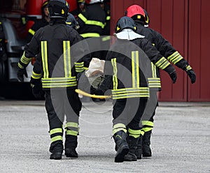 after the road accident, the firefighters carry the seriously in